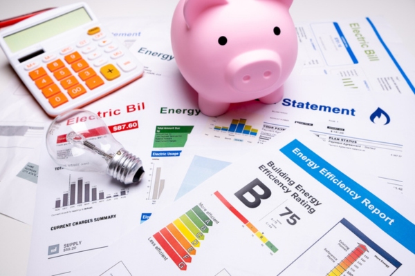 piggy bank on top of bills depicting savings
