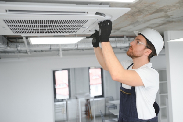 HVAC technician offering in-home assessment during construction