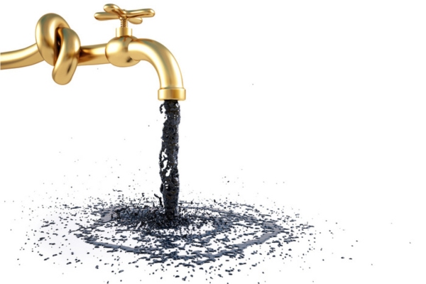 oil draining from faucet depicting draining water from oil tank